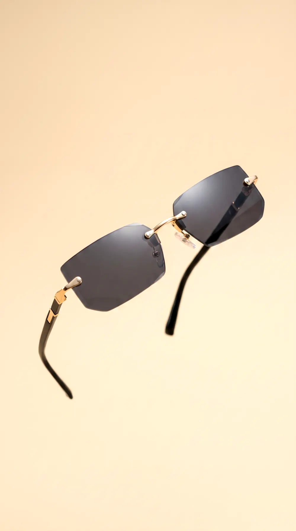 Product-only studio shot: rimless sunglasses on a clean beige backdrop, generated by CherryShot