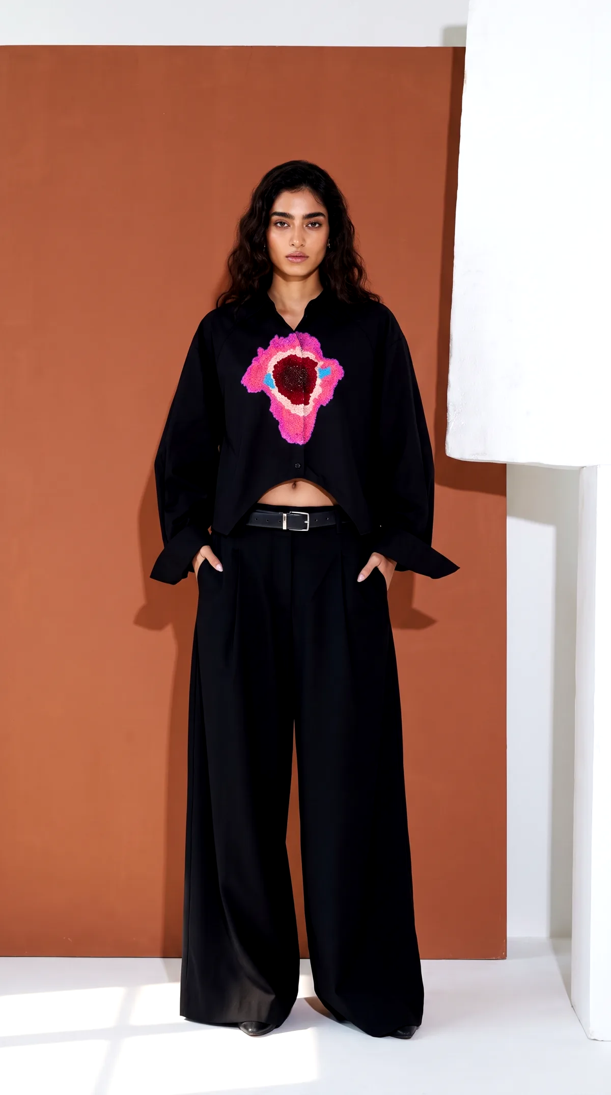 AI generated product photo of a cropped shirt in front of a terracotta colored backdrop panel
