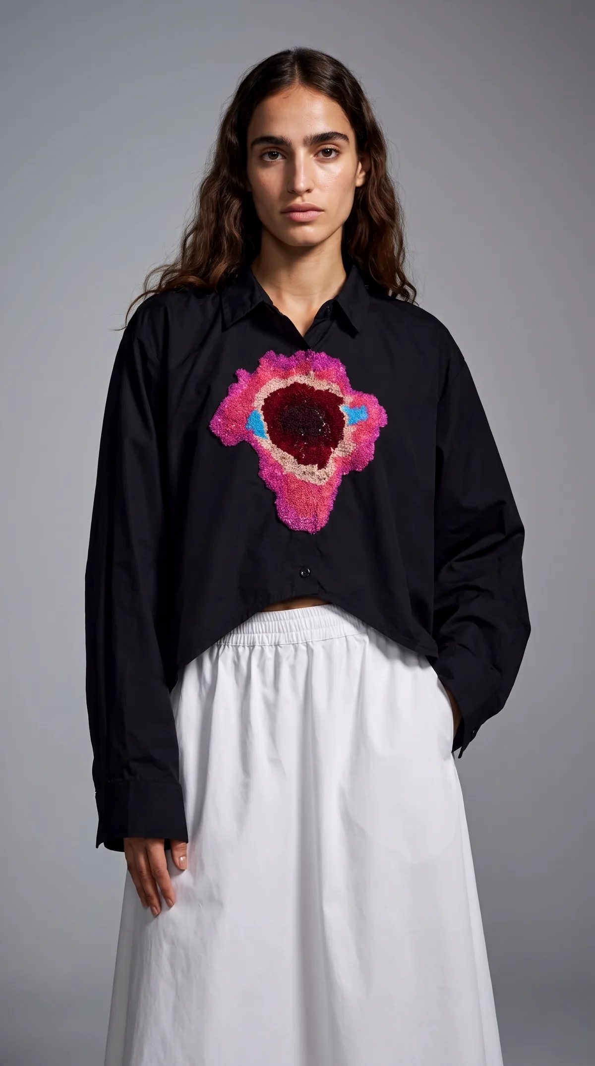 AI generated studio photoshoot of a shirt on a model against a grey backdrop